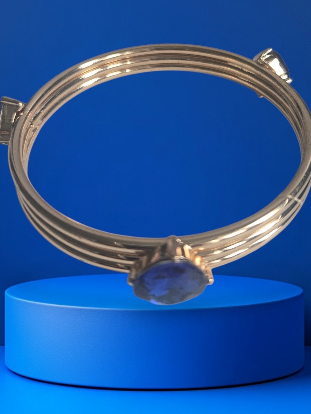 Gold Tone Bracelet with Blue Stone